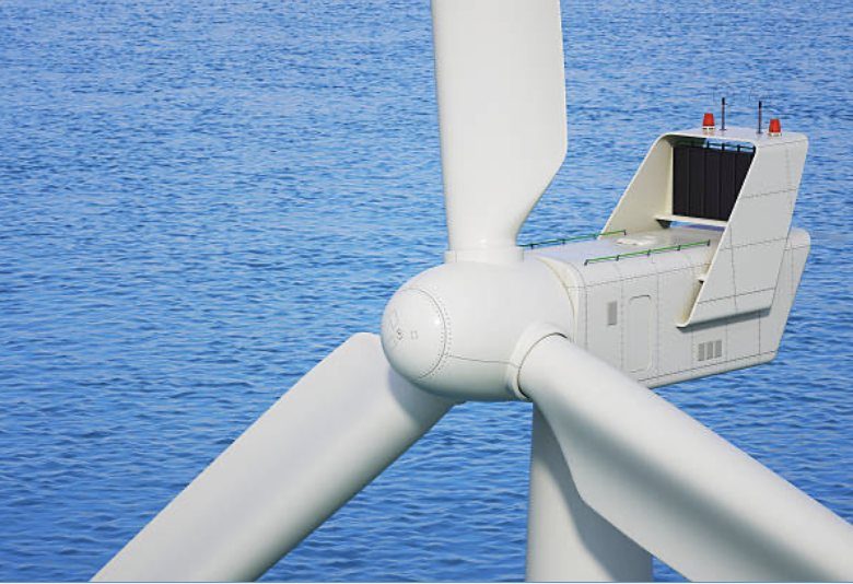 Close view of a wind turbine hub, blades, and nacelle